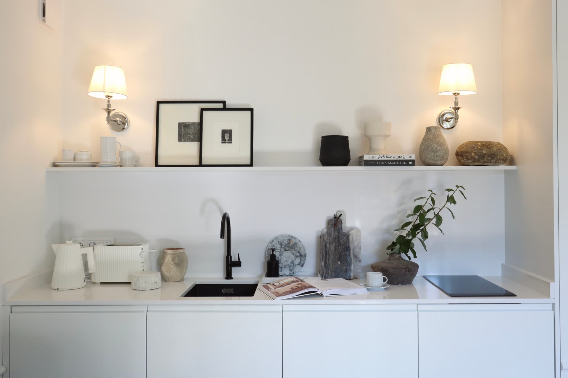 Kuchnia Apartamentu 77 — półki z ceramiką i czarna bateria